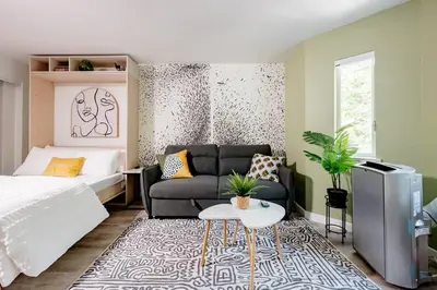 a bedroom with a bed and a couch at Hidden Gem: Historical Gastown in Vancouver
