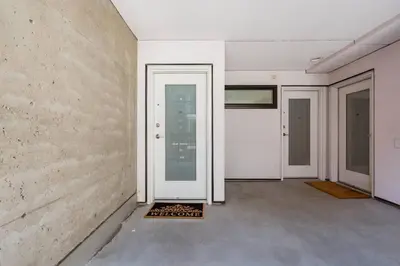 an empty room with a door and three doors at Hidden Gem: Historical Gastown in Vancouver