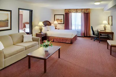 a hotel room with a bed and a couch at Coast Grimshaw Hotel & Suites in Grimshaw
