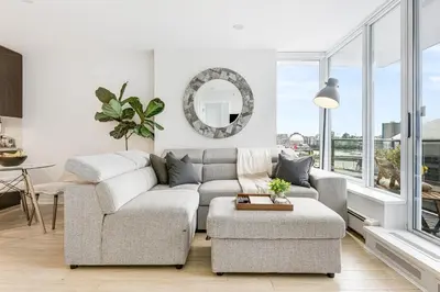 a living room with a couch and a table at Heart of Downtown 1 bd Entire Condo - Pool, Gym, Parking, Office, AC in Vancouver