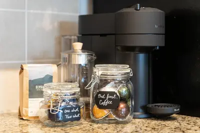 a counter with jars of food and a coffee maker at Heart of Downtown 1 bd Entire Condo - Pool, Gym, Parking, Office, AC in Vancouver