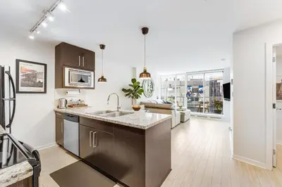 a kitchen with a sink and a counter at Heart of Downtown 1 bd Entire Condo - Pool, Gym, Parking, Office, AC in Vancouver