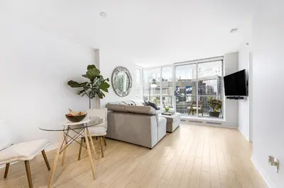 a living room with a couch and a table at Heart of Downtown 1 bd Entire Condo - Pool, Gym, Parking, Office, AC in Vancouver