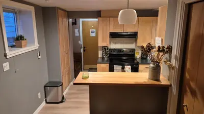 a kitchen with a counter and a stove top oven at Garden suite on Trinity St in Vancouver