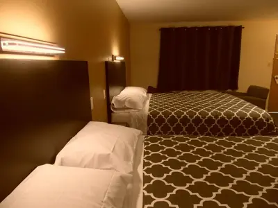 a hotel room with two beds in a room at West View Motel in Hanna