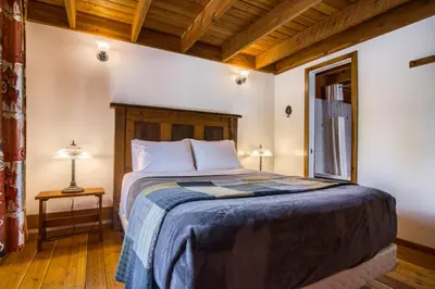 a bedroom with a bed and a window at Timbers Resort in Fairmont Hot Springs