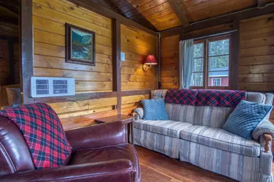 a living room with two couches in a cabin at Timbers Resort in Fairmont Hot Springs