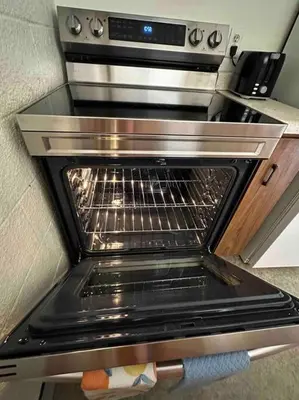 an oven with its door open in a kitchen at Cozy Beach 2 bedroom apartment in Invermere