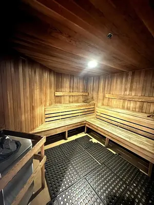 an empty sauna with wooden walls and benches at Stunning ocean (sound of waves) in Vancouver