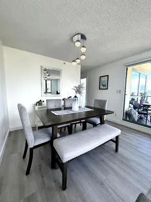 a dining room with a table and two chairs at Stunning ocean (sound of waves) in Vancouver