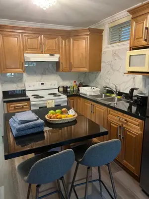 a kitchen with a table with a bowl of fruit on it at Private suite 1 bed 1 bath 15 mins YVR and downtown \u8212\u9002\u5b89\u9759 in Vancouver
