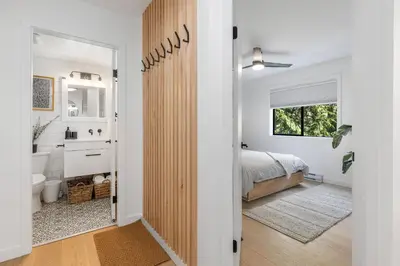 a white bedroom with a bed and a bathroom at Powderview 12 by Whistler Premier in Whistler