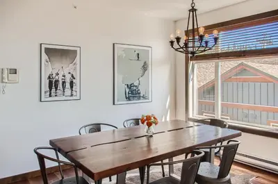 a dining room with a wooden table and chairs at The Crescent 201 by Okanagan Premier in Big White