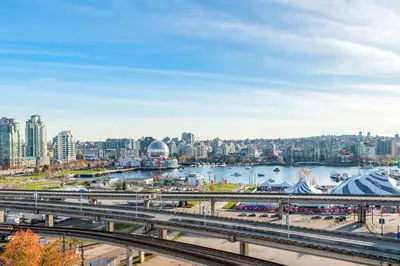 a view of a city with a river and a bridge at Downtown 1 Bedroom Water View Condo in Vancouver