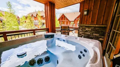 a jacuzzi tub in the middle of a porch at Lush Mountain Accommodations in Golden
