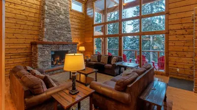 a living room with leather furniture and a fireplace at Lush Mountain Accommodations in Golden