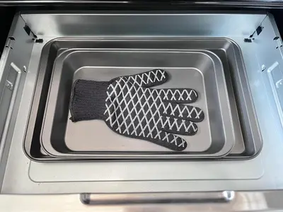 an open oven with a black oven glove in it at Private Entire Townhouse Retreat Close to Lake in Calgary