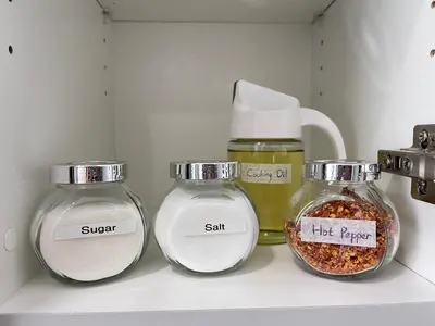 three glass jars sitting on a shelf with spices at Private Entire Townhouse Retreat Close to Lake in Calgary