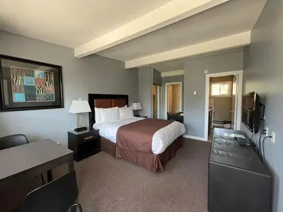 a hotel room with a bed and a desk at Rondo Motel in Golden