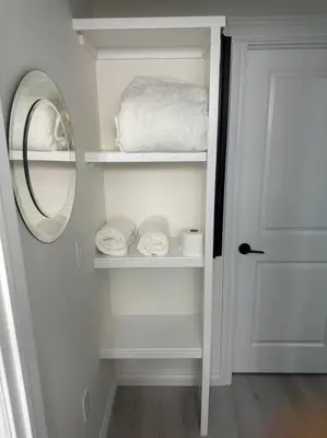 a closet with a mirror and a door with towels at Award winning boho paradise sunlit modern suite in Calgary