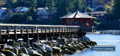 a pier with a gazebo next to the water at Gibsons Garden Hotel in Gibsons