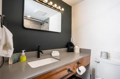 a bathroom with a sink and a mirror at Northwinds Hotel Revelstoke in Revelstoke