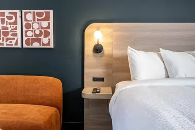 a hotel room with a bed and a chair at Northwinds Hotel Revelstoke in Revelstoke
