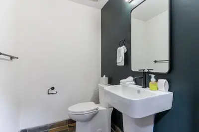 a bathroom with a white toilet and a sink at Northwinds Hotel Revelstoke in Revelstoke