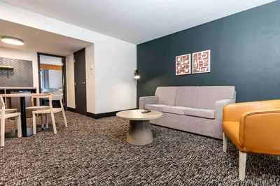 a living room with a couch and a table at Northwinds Hotel Revelstoke in Revelstoke
