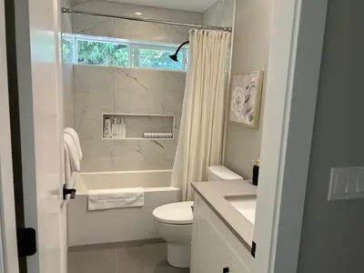 a bathroom with a toilet and a tub and a sink at Blue Sea And Clear Sky B&B LICENCE NUMBER 18952 in Victoria