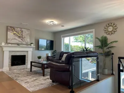 a living room with a couch and a fireplace at Blue Sea And Clear Sky B&B LICENCE NUMBER 18952 in Victoria
