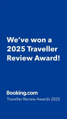 a blue sign that says weve won a traveler review award at Red Robe B&B in Nanaimo