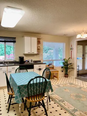 a kitchen with a table and chairs in a kitchen at Red Robe B&B in Nanaimo