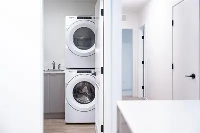 a white laundry room with a washer and dryer at Serenity Now by Revelstoke Vacations in Revelstoke