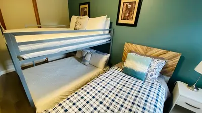 two bunk beds in a room with a small bed at Lux 2BR 5BD Suite Mountain view! in Canmore