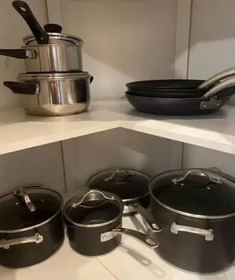 four pots and pans on a shelf in a kitchen at Lux 2BR 5BD Suite Mountain view! in Canmore