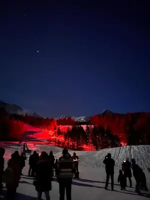 a group of people standing in the snow at night at Mountain View Vacation Villa Main Floor Unit, No Stairs in Fairmont Hot Springs