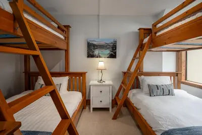 a bedroom with two bunk beds and a lamp at 3BR in Snowberry, King Bed, Wood Burning Fireplace, Large Kitchen, Near Gondola in Whistler