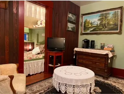 a room with a bedroom with a bed and a tv at The Hazelhouse in Chilliwack