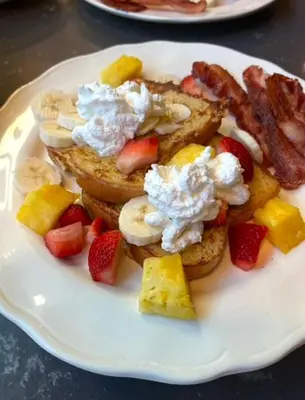 a plate of breakfast food with toast and fruit at The Hazelhouse in Chilliwack