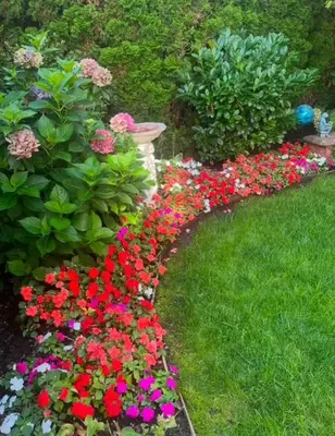 a garden with colorful flowers in the grass at The Hazelhouse in Chilliwack