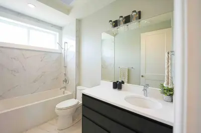 a bathroom with a sink and a toilet and a window at Four bedrooms New Lovely Duplex -1626 in Vancouver