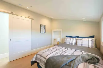 a bedroom with a large bed with blue walls at Four bedrooms New Lovely Duplex -1626 in Vancouver