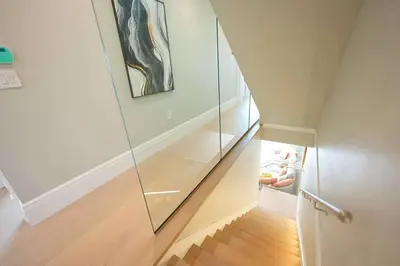 a stairway with a glass case in a house at Four bedrooms New Lovely Duplex House-1628 in Vancouver