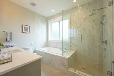 a bathroom with a shower and a tub and a sink at Four bedrooms New Lovely Duplex House-1628 in Vancouver