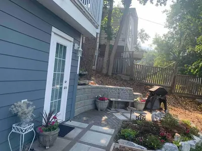 a house with a porch with a dog sitting on a patio at Sweetest Suite Downtown in Salmon Arm
