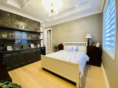 a large bedroom with a bed and a kitchen at Home sweet home in Richmond