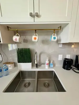 a kitchen counter with a sink and two lights at Home sweet home in Richmond