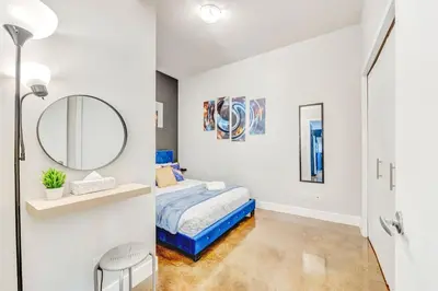 a bedroom with a bed and a mirror at Luxury 2BR Condo - King Bed - Stunning City Views in Calgary