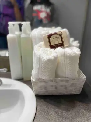 a bathroom with a basket of towels and a sink at Spacious, 2-story Family-Friendly home in Calgary